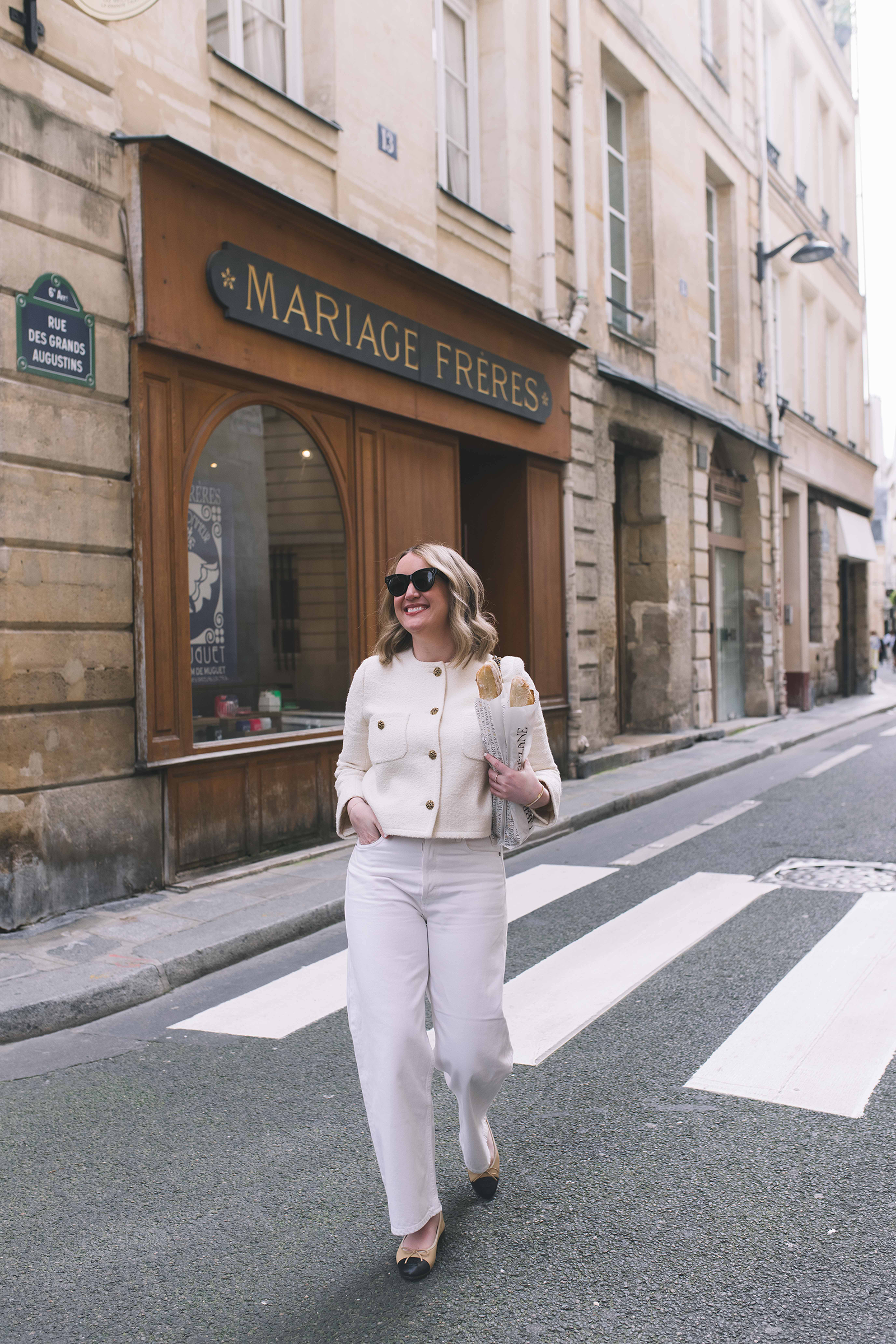Meghan Donovan in white jacket and white trousers in Paris